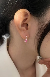 Close-up of pink tulip pendant earrings with silver edges on a female model