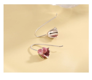 Macro shot of 3D pink tulip earrings with silver hooks and delicate floral enamel detail