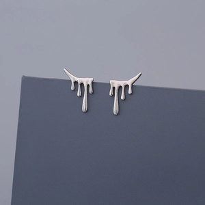 Detailed view of silver lava teardrop earrings with a liquid metallic mirror finish