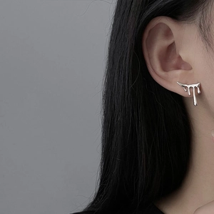 Close-up of S925 silver lava earrings with liquid metal droplet design on female model