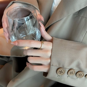 Elegant gold S925 interlocking ring with sparkling crystals worn by a model