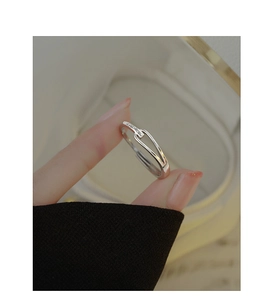Detail of interlocking S925 silver ring with pavé cubic zirconia on adjustable band