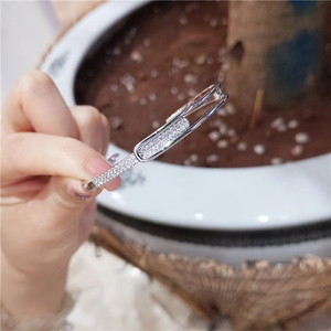 Detail of silver safety pin open bracelet with micro-pave white cubic zirconia stones