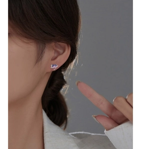 Detailed view of S925 silver heart earring with blue-purple gradient stone on ear