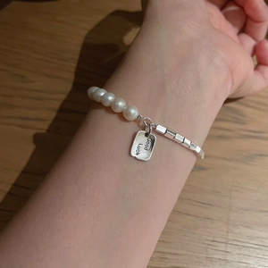 S925 silver bracelet featuring white pearls and a rectangular Good Luck charm