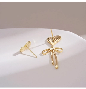 Elegant gold-tone S925 silver asymmetric heart earrings with chic bow tassel details