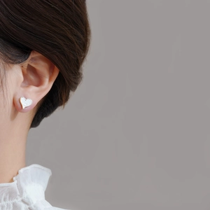 Elegant S925 silver heart earrings with mother of pearl inlay shown on model