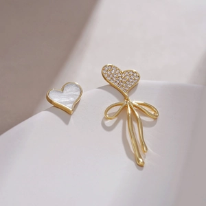 Elegant S925 silver asymmetric mother of pearl heart earrings with bowknot tassels