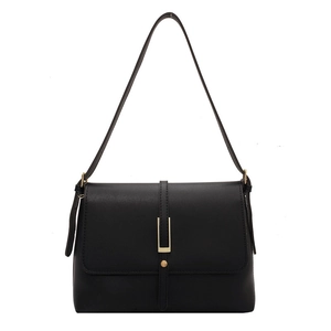 Minimalist black leather crossbody bag with matte finish and gold U-shaped metal buckle