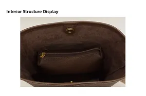 Internal structure of the brown bucket bag showing the zipper pouch and magnetic clasp