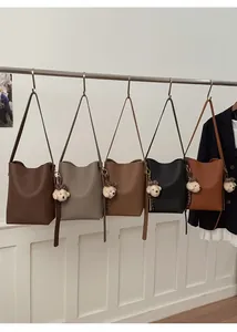 Close-up of minimalist bucket bag series in five colors with cute bear charms