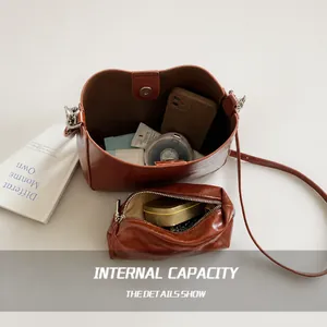 Interior view of red-brown leather bucket bag showing large capacity for essentials