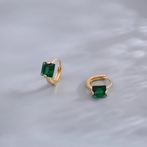 Elegant gold earrings featuring emerald cut green gemstones in a four-prong setting