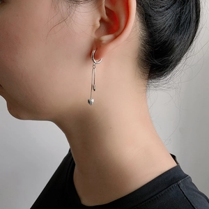 Gros plan de boucles d'oreilles créoles en argent S925 avec pompons de coeur