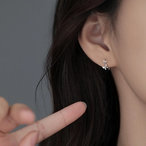 Elegant S925 sterling silver butterfly stud earrings worn by a model in a close-up view