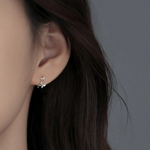 Detailed close-up of S925 silver double butterfly ear hooks on model ear