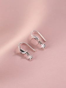 Détail du poinçon S925 sur des boucles d'oreilles vintage lune et étoile en argent