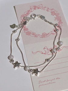 S925 silver double-layered bracelet featuring star charms and beads on pink background
