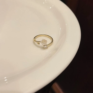 Detailed close-up of gold S925 silver ring featuring a white camellia flower and zircon