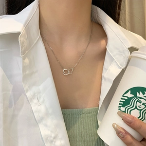 Minimalist S925 silver double heart pendant necklace shown on a model neck
