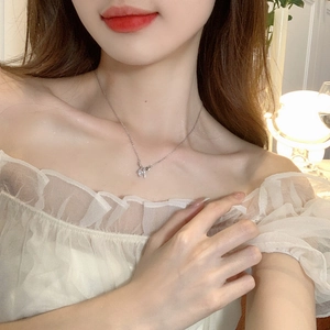 S925 silver bow necklace with zircon heart pendant shown on model's neck for elegant look