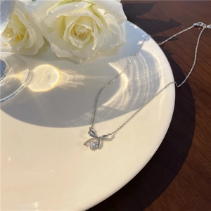 Elegant S925 silver necklace with bow pendant and heart cubic zirconia on white tray