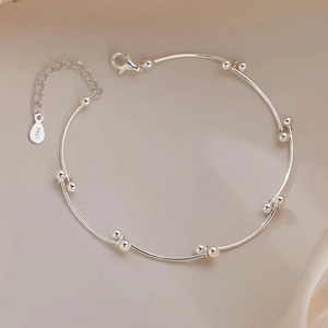 Detailed view of S925 sterling silver stamp on minimalist beaded segmented bracelet