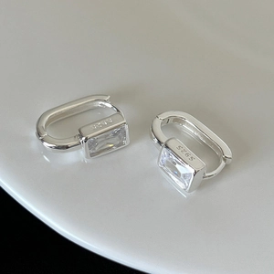 Close-up of S925 silver stamp and rectangle zircon on geometric hoop earrings