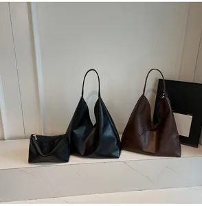 Detail view of large capacity vintage tote bag set in black and brown leather