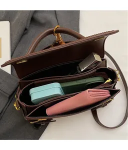 Top view of spacious three-compartment interior showing organized storage for phone and wallet