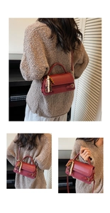 Detail of dark red vintage square handbag with retro bead charm and top handle