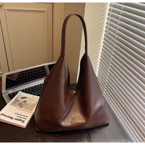 Detail of vintage brown tote bag with leather texture and large capacity for work