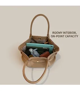 Interior view of light brown leather tote bag showing large capacity and daily essentials