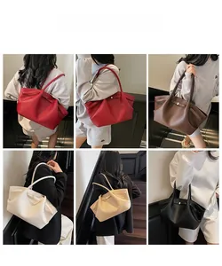 Collage of chic underarm tote bags in multiple colors featuring pebbled leather and side folds