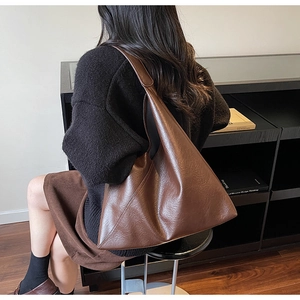 Detail of a large vintage dark brown tote bag with a minimalist geometric stitch design