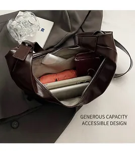 Interior view showing the large storage capacity of this dark brown glossy shoulder bag