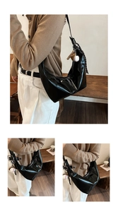 Three-way view of shiny black hobo bag with silver zipper and baseball charm