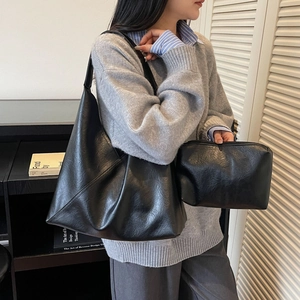 Retro black faux leather hobo tote bag set with matching pouch worn by model