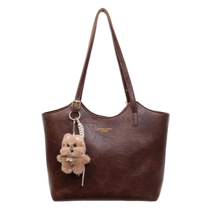 Retro dark brown leather tote bag with bear charm and long shoulder straps for daily use