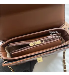 Detailed interior of quilted crossbody bag showing smooth zipper and gold chain strap