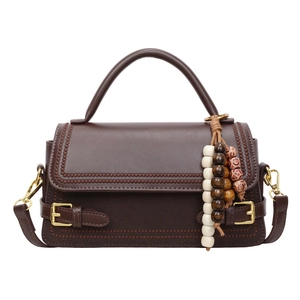 Retro dark brown crossbody bag with decorative stitching and wooden bead tassel pendant