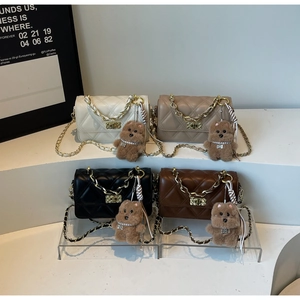 Detailed display of four quilted chain bags in white, beige, black, and brown with bear charms