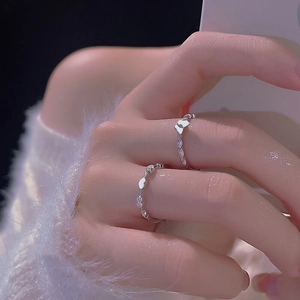 Detail of s925 silver ring set featuring micro-paved butterfly and heart designs