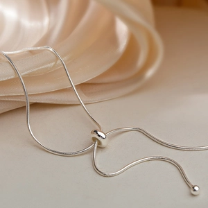 Elegant s925 silver beaded drawstring necklace with polished snake chain and silk background
