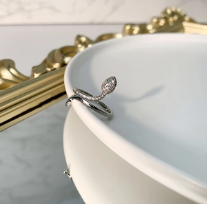 S925 sterling silver snake ring with green eyes and white zircon stones in an open design