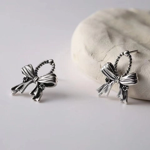 Vintage S925 silver bow stud earrings with textured brushed finish and beaded chain detail
