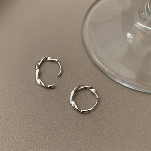 Minimalist S925 sterling silver Mobius hoop earrings with twisted metal texture