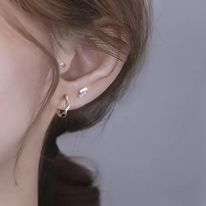 Minimalist S925 sterling silver Mobius earrings set on model with a polished finish