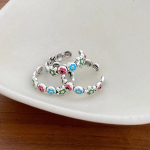 Close-up of S925 sterling silver open rings with colorful enamel floral patterns