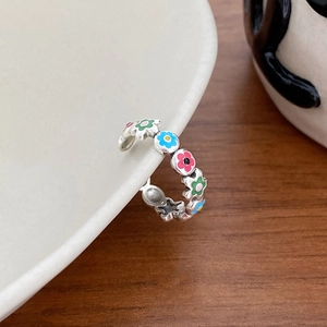 Detail of S925 silver adjustable open ring with colorful floral enamel patterns